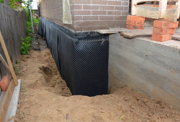 Happy homeowners after waterproofing job in Weaver